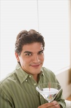 Portrait of smiling man having cocktail. Photo : Rob Lewine