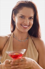 Portrait of smiling woman with cocktail. Photo : Rob Lewine