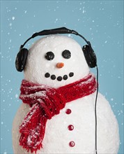 Studio shot of snowman wearing headphones.