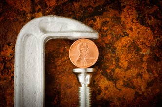 Studio shot of coin in vise grip.