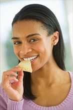 Woman eating potato chips.