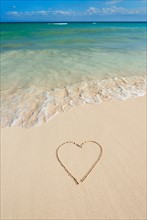 Mexico, Yucatan. Heart drawing in sand on beach.