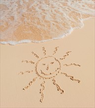 Mexico, Yucatan. Sun drawing on beach.