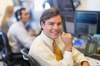 Portrait of male trader at trading desk.