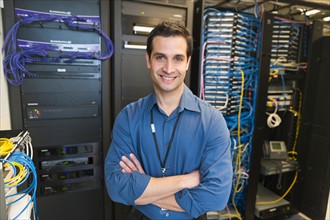 Portrait of technician in network server room.