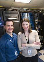 Portrait of technicians in network server room.