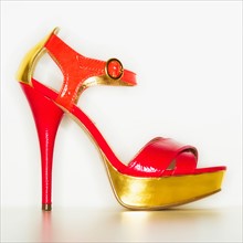 Studio shot of red and gold stiletto.