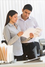 Businesswoman and businessman in office.