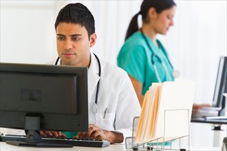 Doctors working on computers.