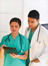 Doctors using digital tablet.