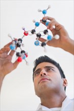 Man holding molecular model.