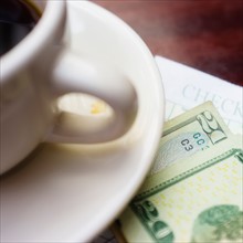 Coffe and banknote on table.