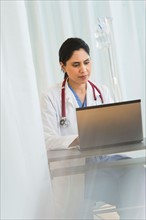 Doctor working on laptop.