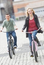 Couple cycling on street.