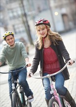 Couple cycling on street.
