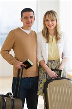 Couple with luggage and passports.