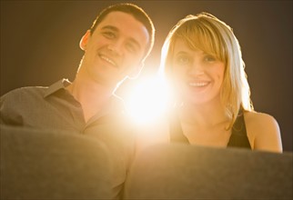 Couple in cinema with light behind.