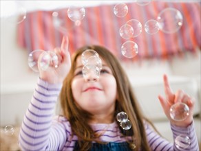 Small girl  (4-5 years) playing with bubbles. Photo : Jamie Grill