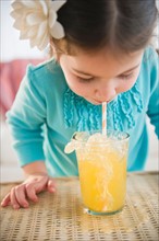 Small girl  (4-5 years) drinking juice with straw. Photo : Jamie Grill