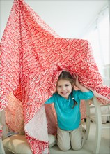 Small girl  (4-5 years) playing with curtain. Photo : Jamie Grill