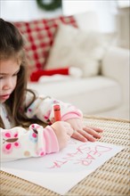 Portrait of small girl  (4-5 years) writing letter to Santa Claus. Photo : Jamie Grill