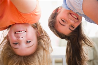 Close up of two girls upside down. Photo : Jamie Grill