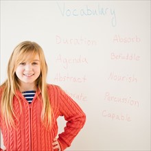 Portrait of girl in front of whiteboard. Photo : Jamie Grill