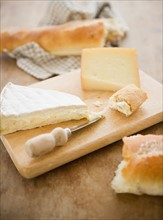 Close up of cheese and baguette on table, studio shot. Photo : Jamie Grill