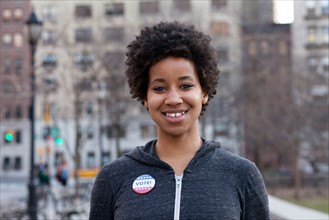 USA, New York, New York City. Portrait of woman with vote pin. Photo : Winslow Productions