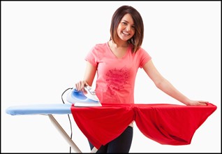 Young woman ironing. Photo : Mike Kemp