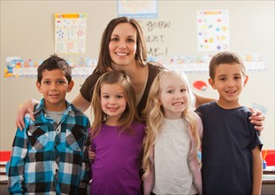 Teacher with children (2-3, 4-5, 6-7) at school. Photo : Mike Kemp