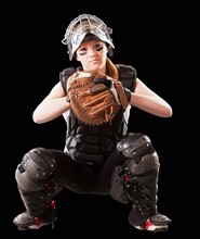 Girl (12-13) plying softball, studio shot. Photo : Mike Kemp