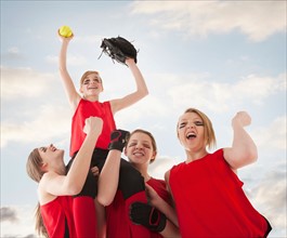 Girls (12-13) celebrating during playing softball. Photo : Mike Kemp