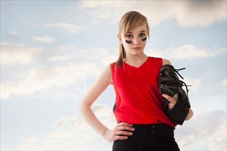 Portrait of girl (12-13) plying softball. Photo : Mike Kemp