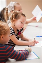 Children (4-5) drawing in kindergarten. Photo : Mike Kemp