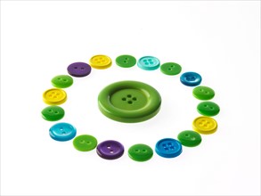 Studio shot of multi colored buttons arranged in circle. Photo : David Arky