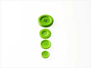 Studio shot of green buttons in a row. Photo : David Arky