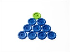 Studio shot of blue and green buttons arranged in triangle. Photo : David Arky