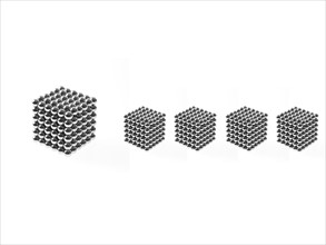 Studio shot of Pachinko balls arranged in group of cubes. Photo : David Arky