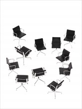 Corporate chairs forming irregular pattern on white background. Photo : David Arky