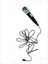 Studio shot of microphone and microphone cable on white background. Photo : David Arky
