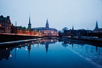 Denmark, Copenhagen. View over canal towards Copenhagen Stock Exchange and Christiansborg Castle.