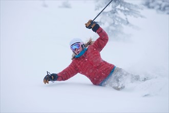 USA, Montana, Whitefish. Woman skiing powder . Photo : Noah Clayton