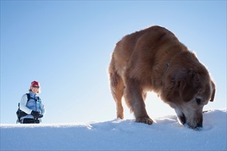 USA, Montana, Bob Marshall Wilderness, Mt.Aeneus. Woman hiking with her dog in winter scenery.