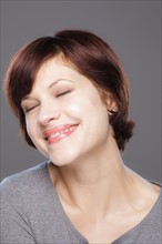 Studio shot of smiling young woman. Photo : Rob Lewine