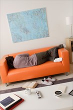 Man sleeping on sofa. Photo : Rob Lewine