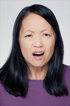 Studio portrait of mature woman with facial expression. Photo : Rob Lewine