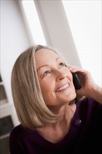 Portrait of smiling senior woman talking via mobile. Photo : Rob Lewine