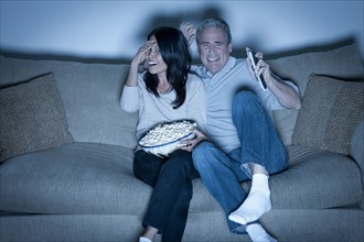 Couple watching television. Photo : Rob Lewine