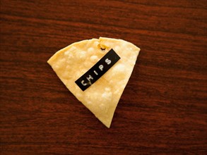 Close-up view of nacho chip with label reading chips. Photo : Jessica Peterson